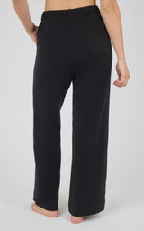 Black marled pique lounge pants with a high elastic waistband and relaxed wide legs, shown from behind.