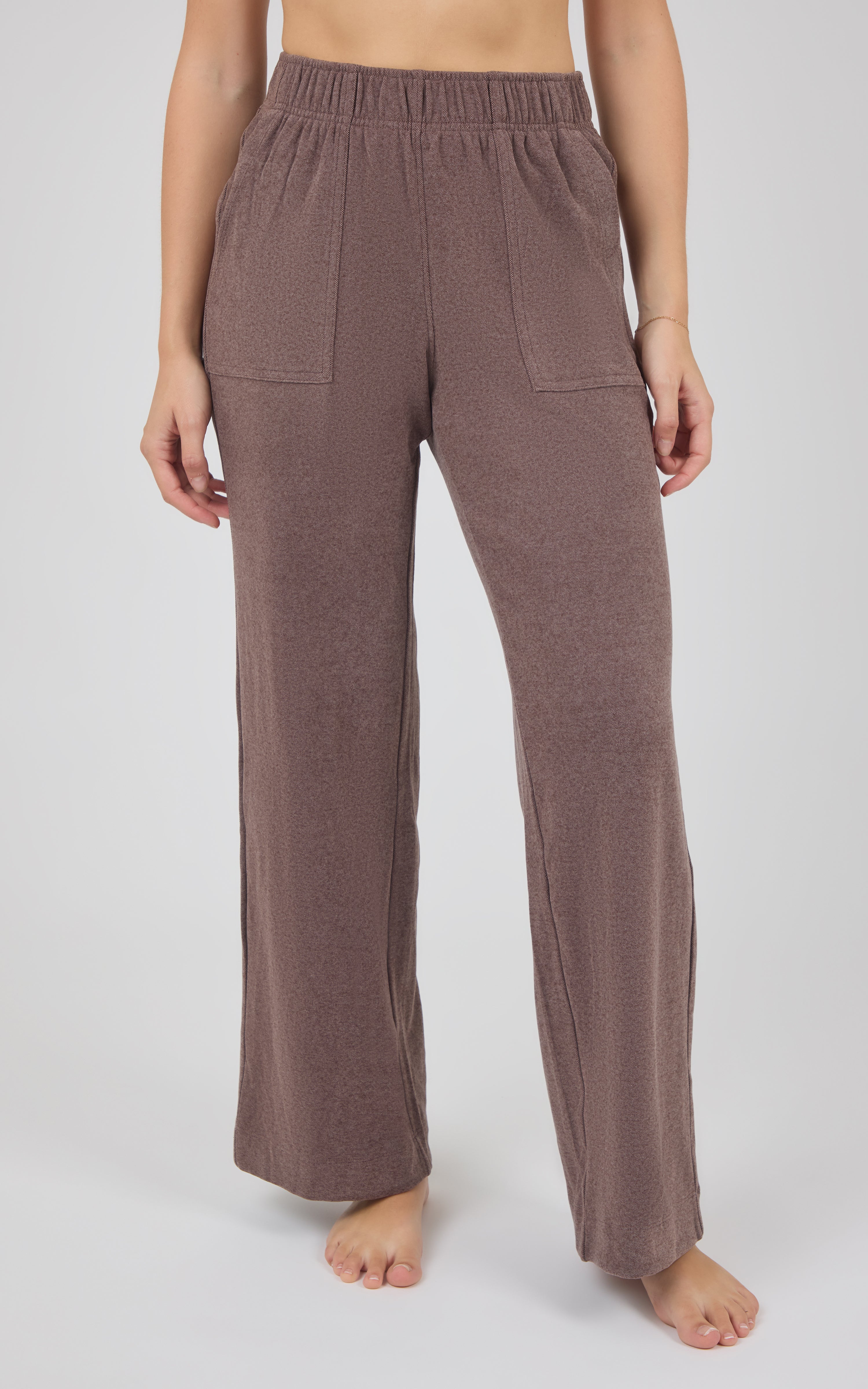 Taupe-brown marled pique lounge pants with a gathered elastic waist, side pockets, and relaxed wide legs.