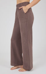 Brown marled pique lounge pants with a wide-leg silhouette, elastic waistband, and relaxed fit, shown on a model.