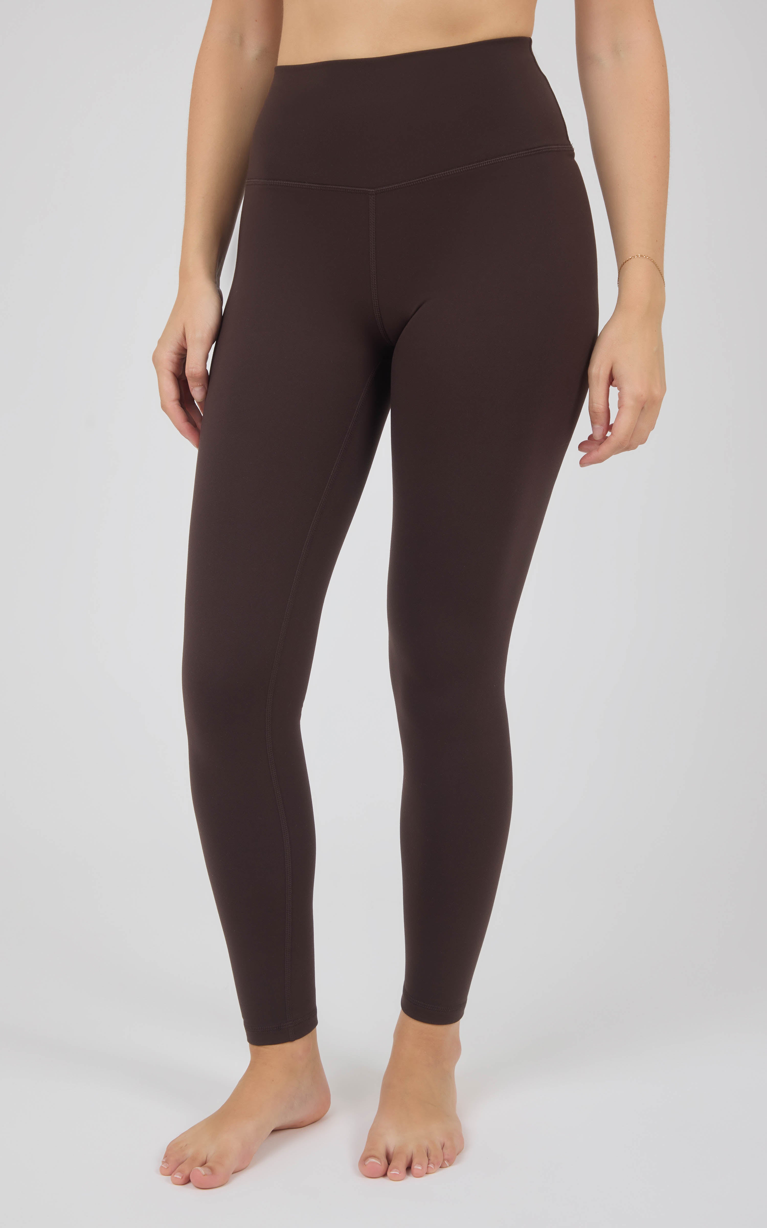 Dark brown, high-rise full-length leggings with a smooth, close-fitting silhouette and ankle-length hems.