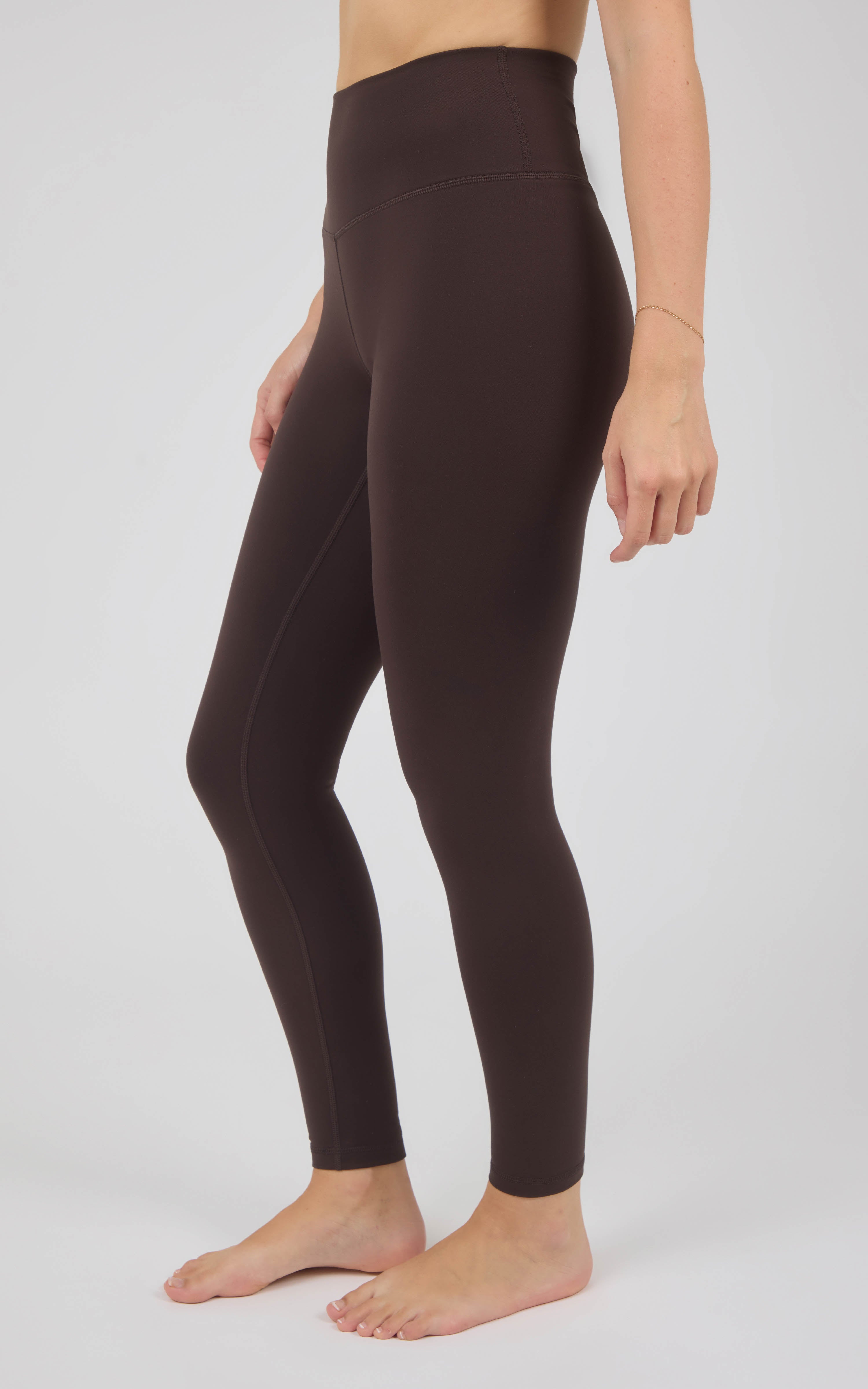 Dark brown, high-rise full-length fleece leggings with a smooth, close-fitting silhouette and ankle-length legs.