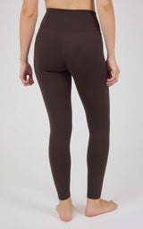 Dark brown high-rise full-length leggings with a smooth, fitted silhouette and ankle-length tapered legs.