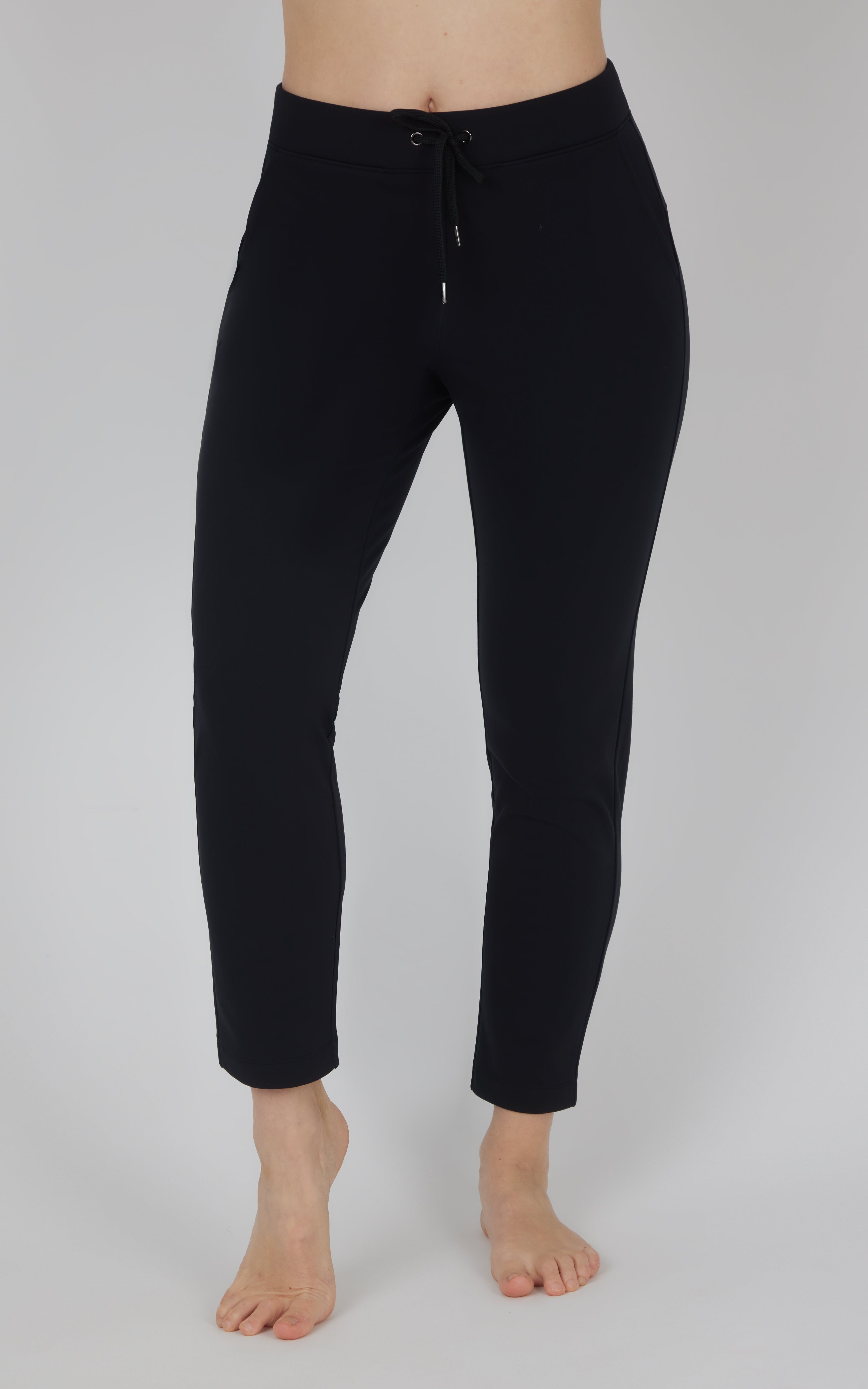 Black fleece straight-leg pants with a smooth finish, elastic waistband, and drawstring, shown cropped at the ankles.