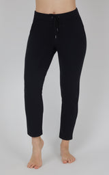 Black fleece straight-leg pants with a smooth finish, elastic waistband, and drawstring, shown cropped at the ankles.