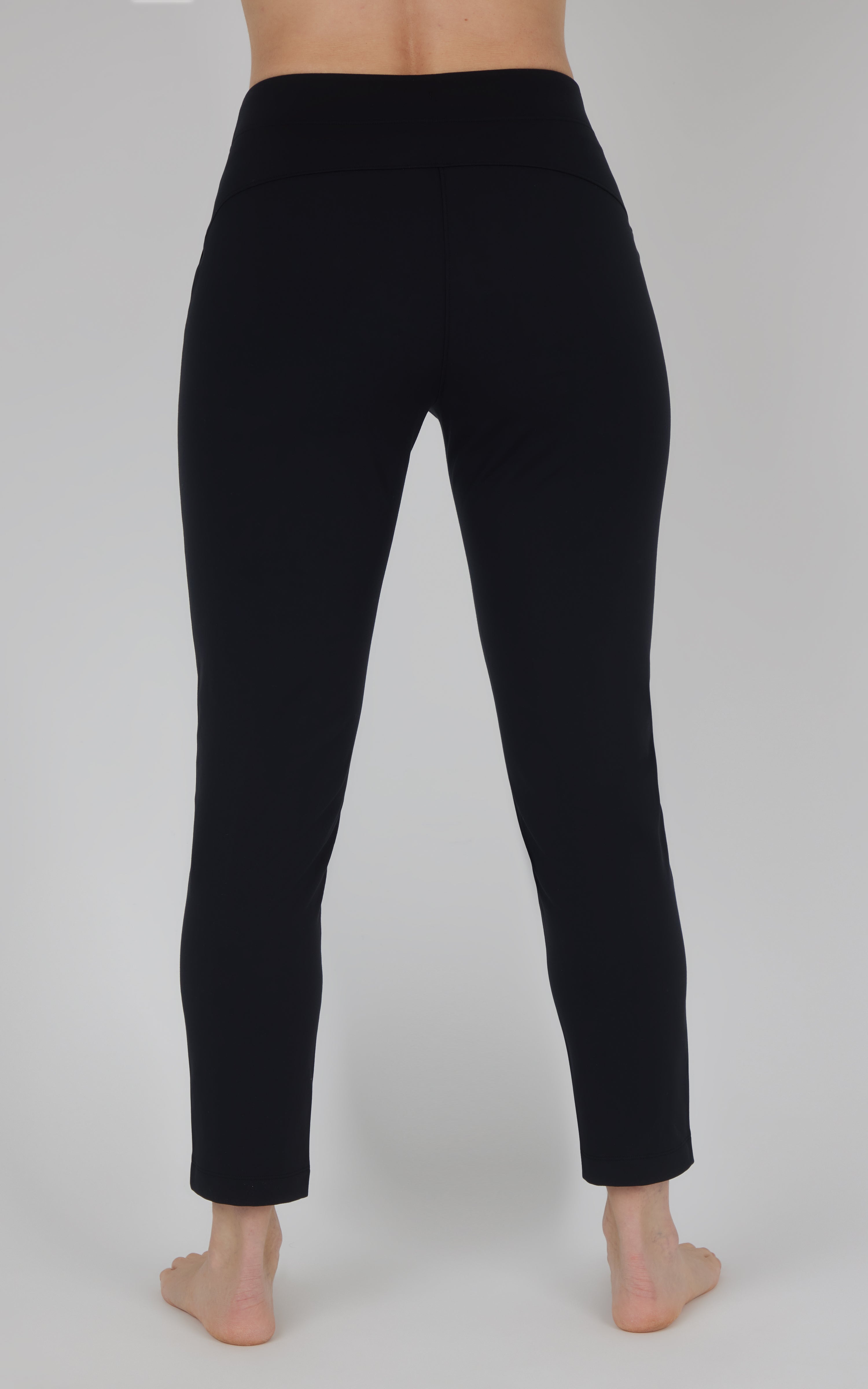 Black straight-leg pants with a smooth, fleece-like finish, cropped above the ankles and shown from behind.