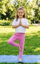 Girl wearing mauve jogger pants with a relaxed tapered fit and drawstring waist, standing outdoors.
