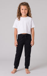 Girl modeling black tapered jogger pants with a drawstring waist and side pockets.