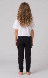 Back view of a girl wearing black tapered joggers with a soft fleece finish and elastic cuffs.