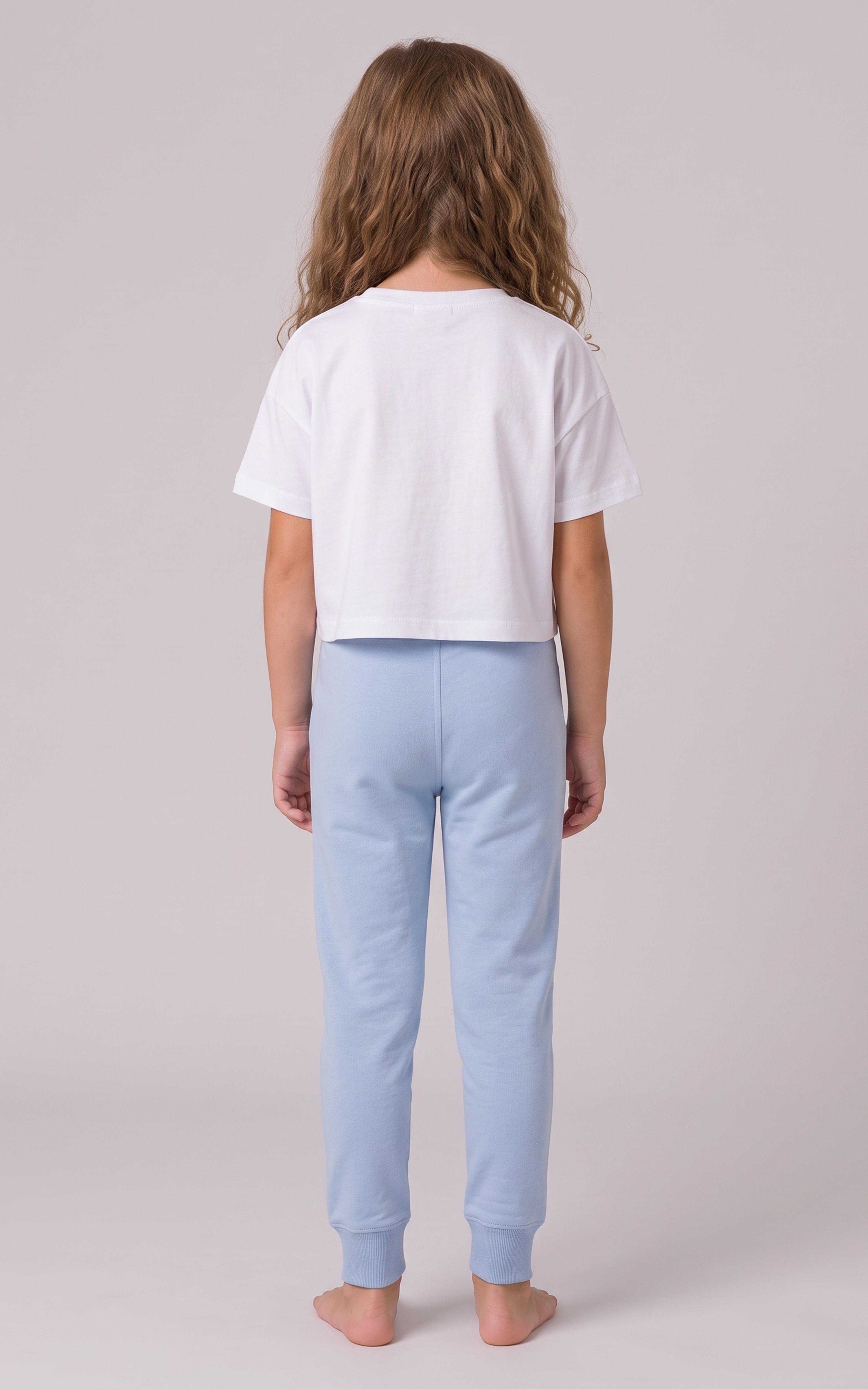 Back view of a girl wearing light blue tapered joggers with an elastic waistband and cuffed ankles.