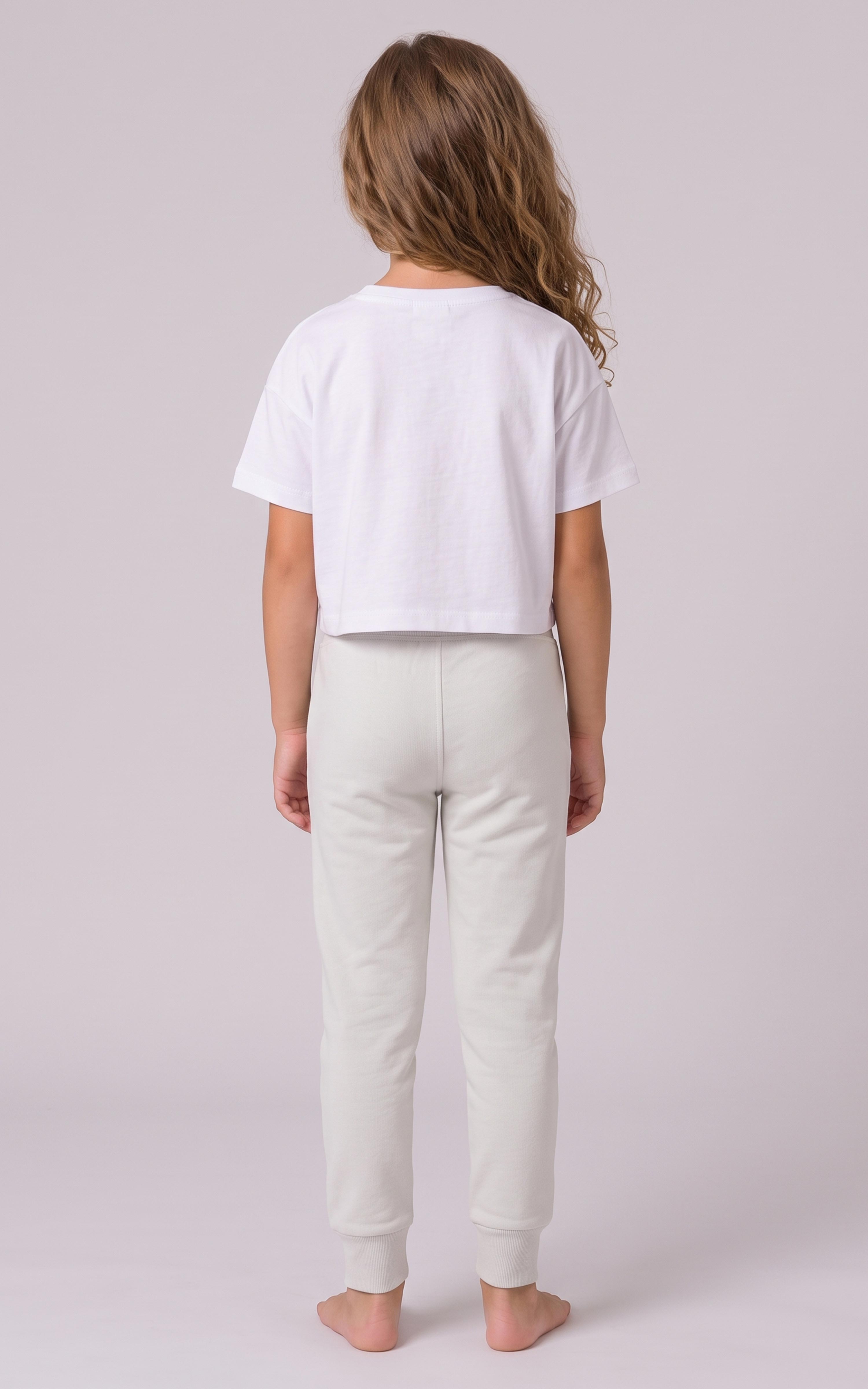 Girl modeling light gray tapered joggers with a relaxed fit and elastic cuffs, shown from behind.