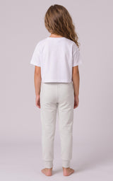 Girl modeling light gray tapered joggers with a relaxed fit and elastic cuffs, shown from behind.