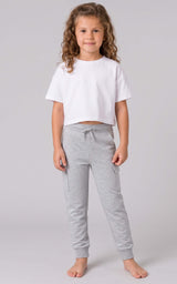 Girl modeling light gray tapered joggers with an elastic drawstring waist and side pockets.