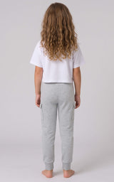 Back view of a girl wearing light gray tapered joggers with an elastic waistband and cuffed ankles.