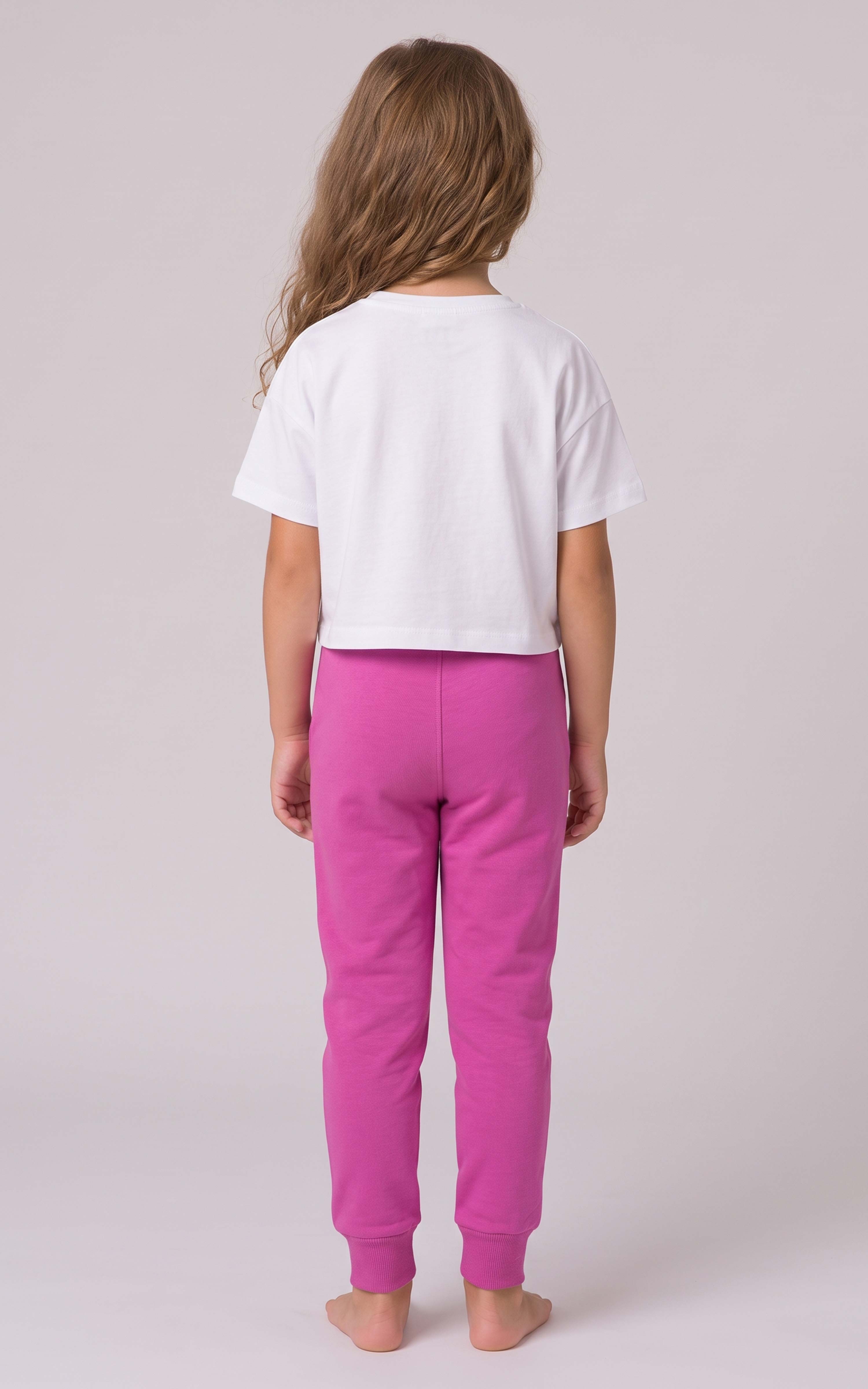 Back view of a girl wearing bright pink tapered joggers with an elastic waistband and gathered ankle cuffs.