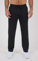 Black straight-leg pants with elastic waistband and drawstring, made from soft lightweight fabric, worn with white sneakers.