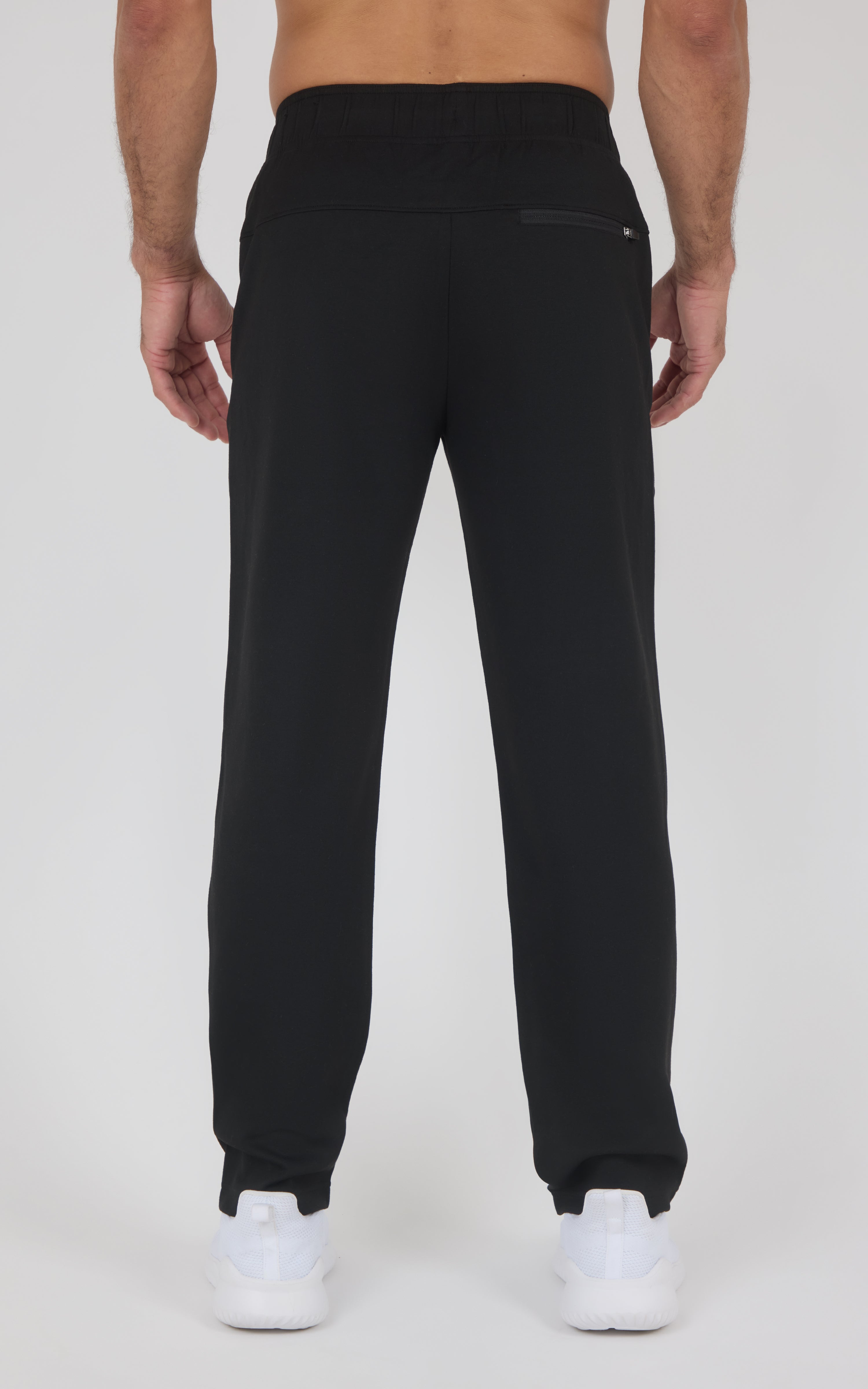 Black straight-leg soft fabric pants with elastic waistband and ankle cuffs, rear zip pocket visible.