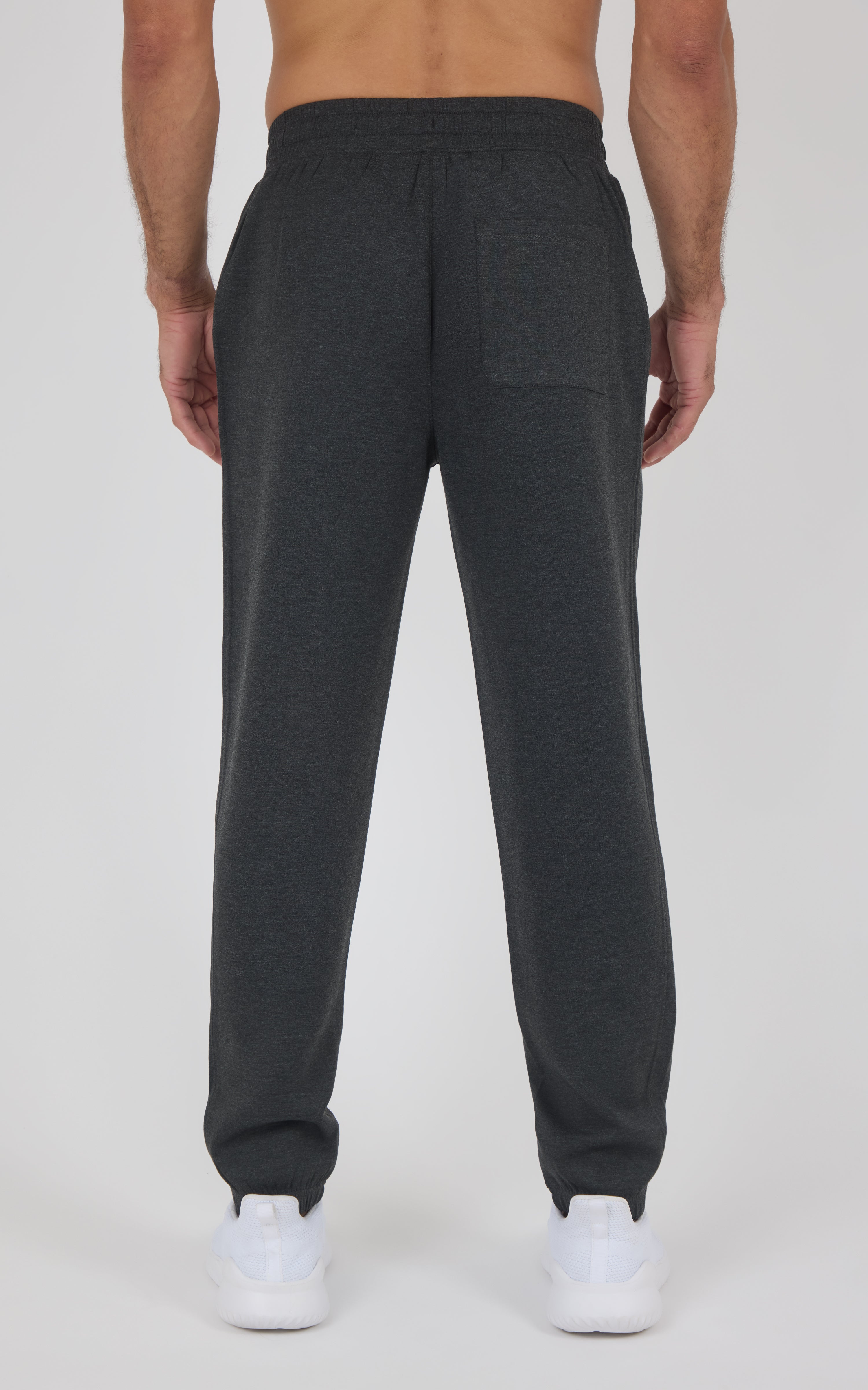 Men’s dark charcoal jogger pants with a relaxed fit, elastic cuffs, and a back patch pocket, shown from behind.