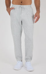 Light gray heathered joggers with a drawstring waist, side pockets, tapered cuffs, and white sneakers.
