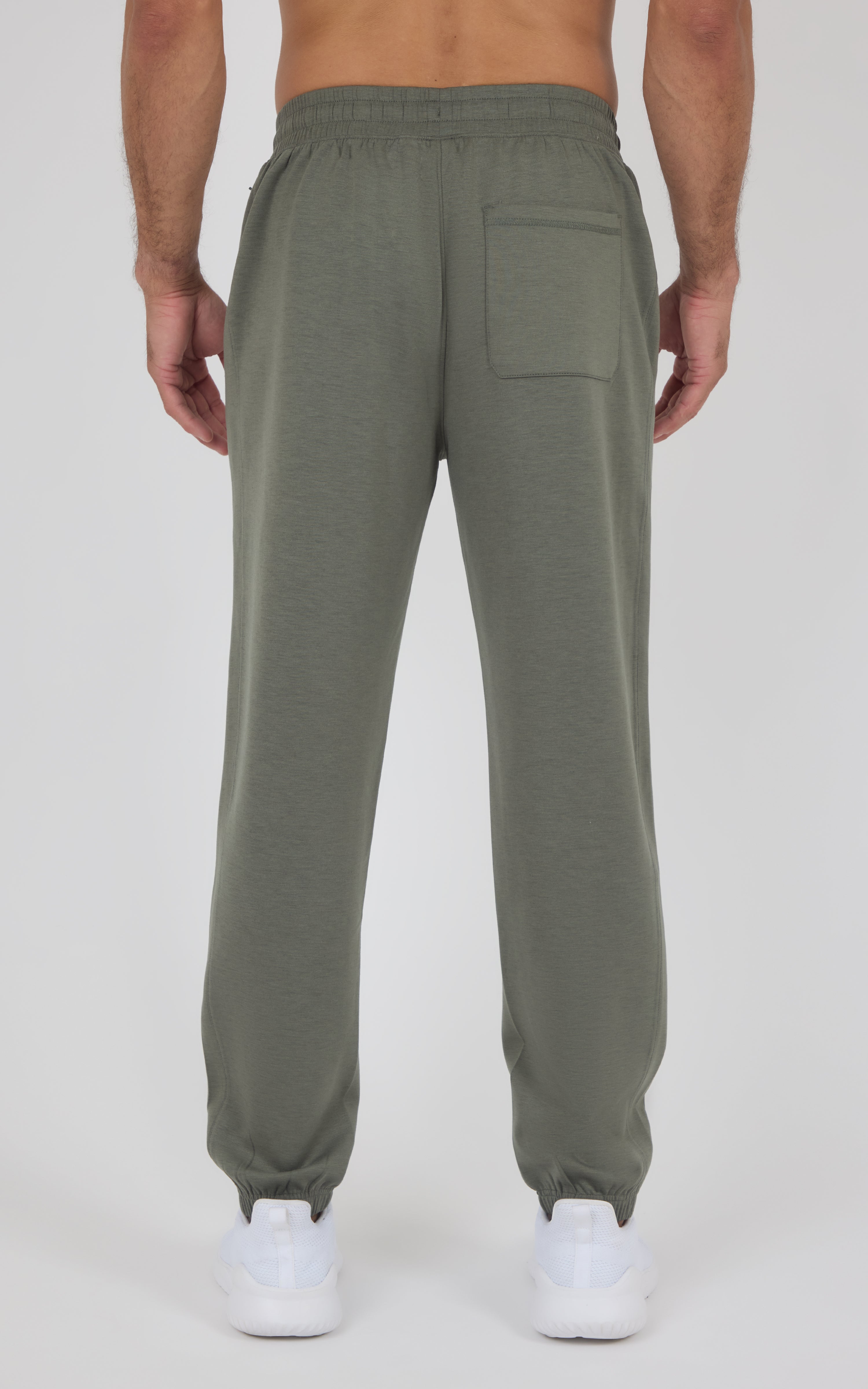 Back view of olive-gray joggers with a relaxed fit, elastic cuffs, and a large patch pocket on the right leg.