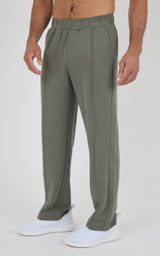 Men's olive green straight leg pants with a flat front and side pockets, worn with white sneakers.