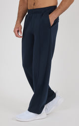 Navy blue straight-leg pants with a soft fabric texture, elastic waistband, and side pockets, worn by a male model paired.