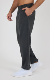 Charcoal gray men's joggers with a soft fabric texture, elastic waistband, side pockets, and a relaxed fit tapered at the.