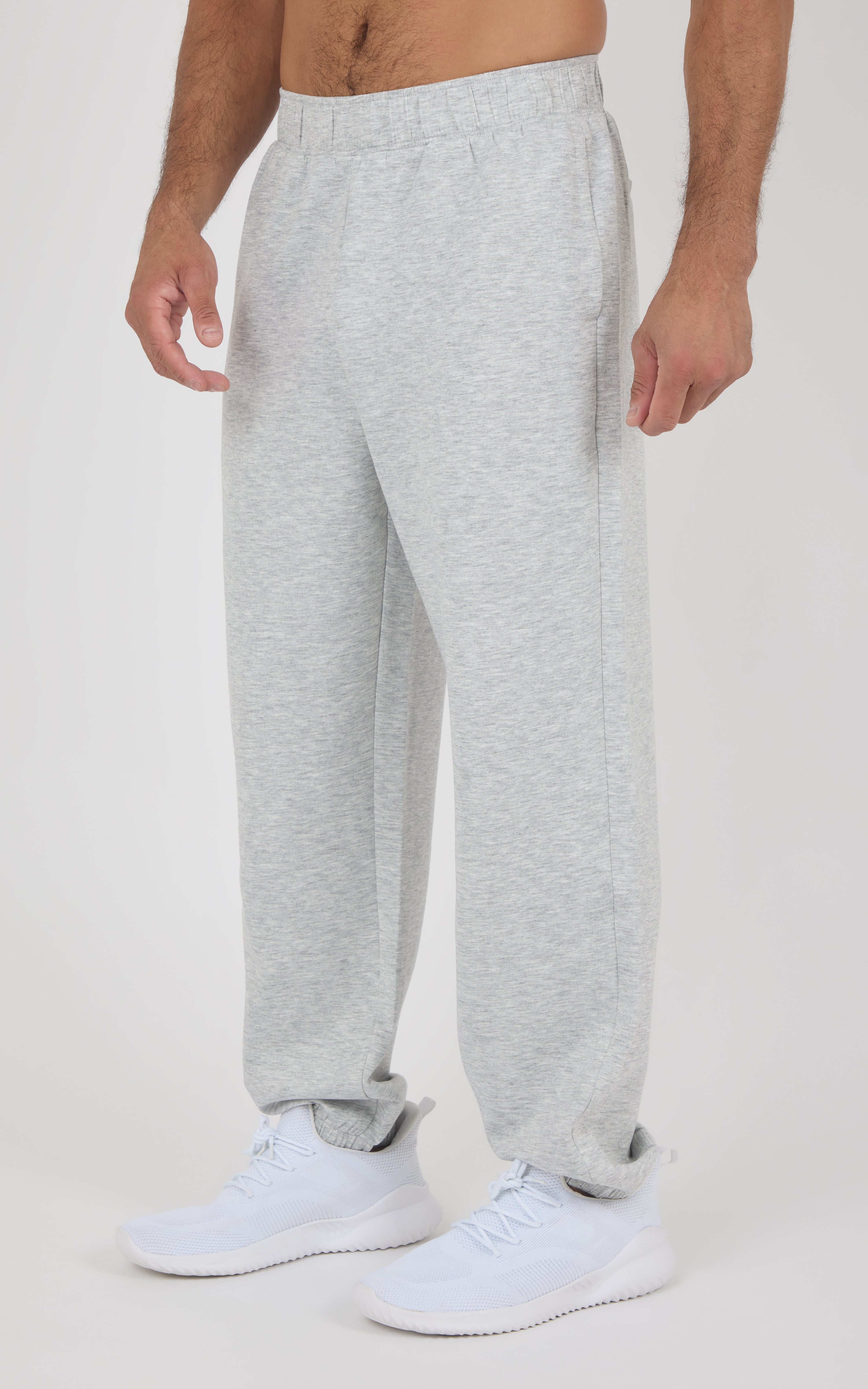 Light gray soft fabric jogger pants with elastic waistband and relaxed fit on a male model.