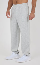 Light gray soft fabric jogger pants with elastic waistband and relaxed fit on a male model.