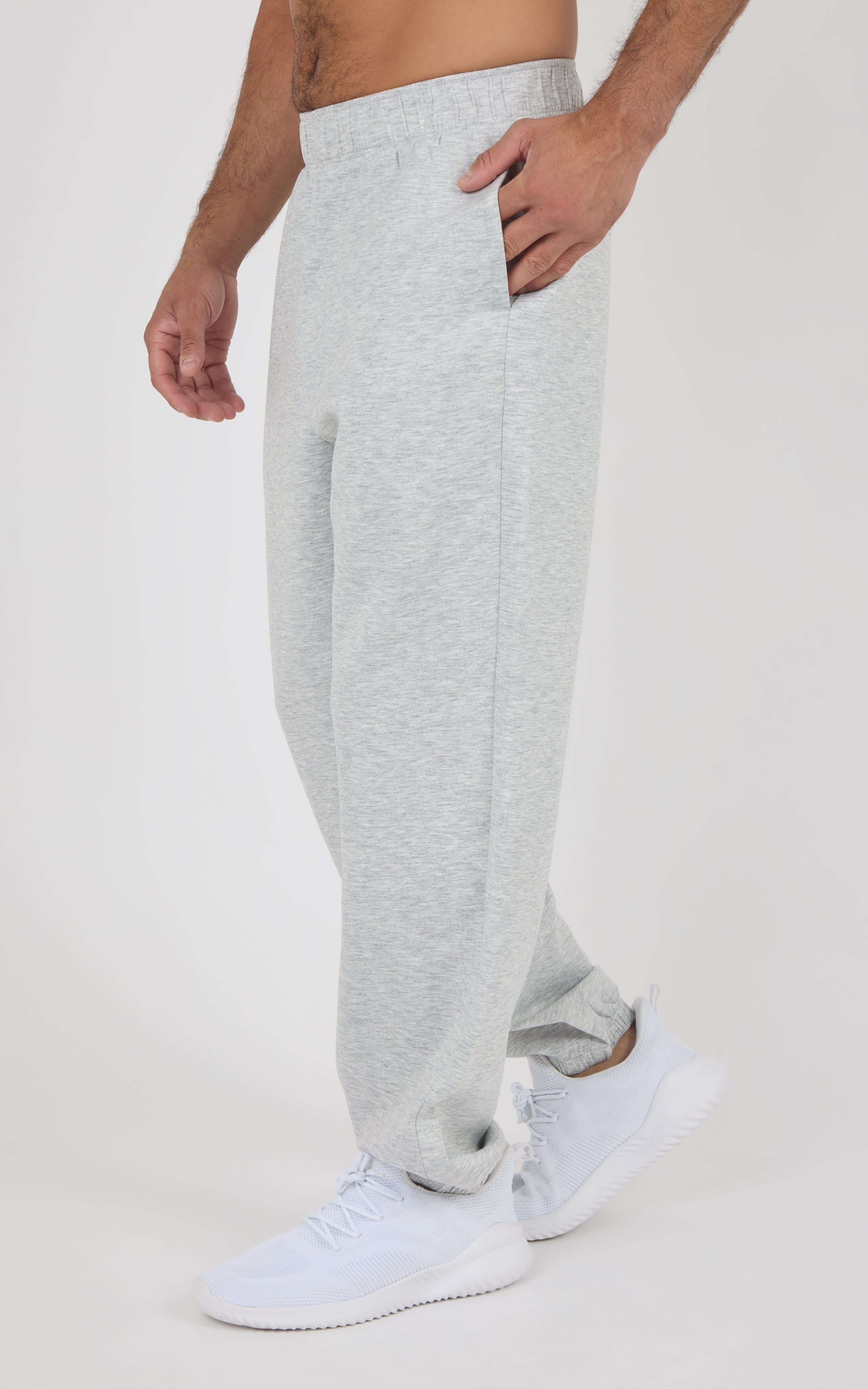 Light gray fleece joggers with a relaxed fit, elastic waistband, side pockets, and cuffed ankles worn with white sneakers.