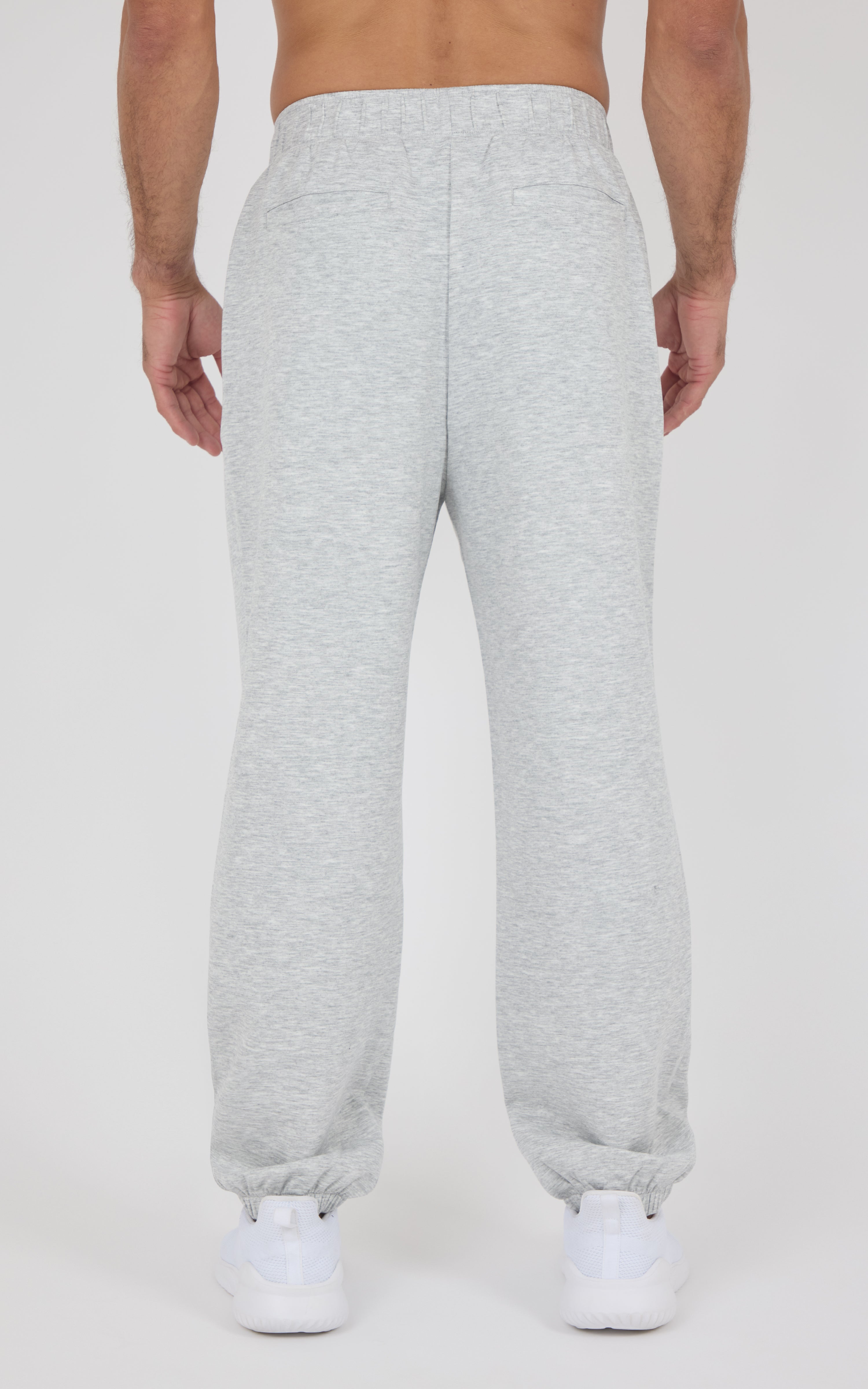 Light gray men's jogger pants with elastic waistband and cuffs, made of soft fabric, shown from the back.
