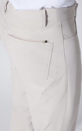 Close-up of a person wearing light beige trousers, showing the back pocket and waistband details against a plain white background.