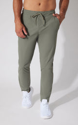 Men's slim-fit joggers in muted green with drawstring waist and cuffed ankles.