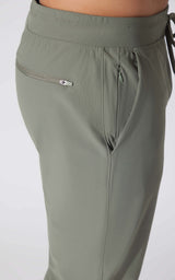 Light green men's jogger pants with elastic waistband and zippered side pocket.