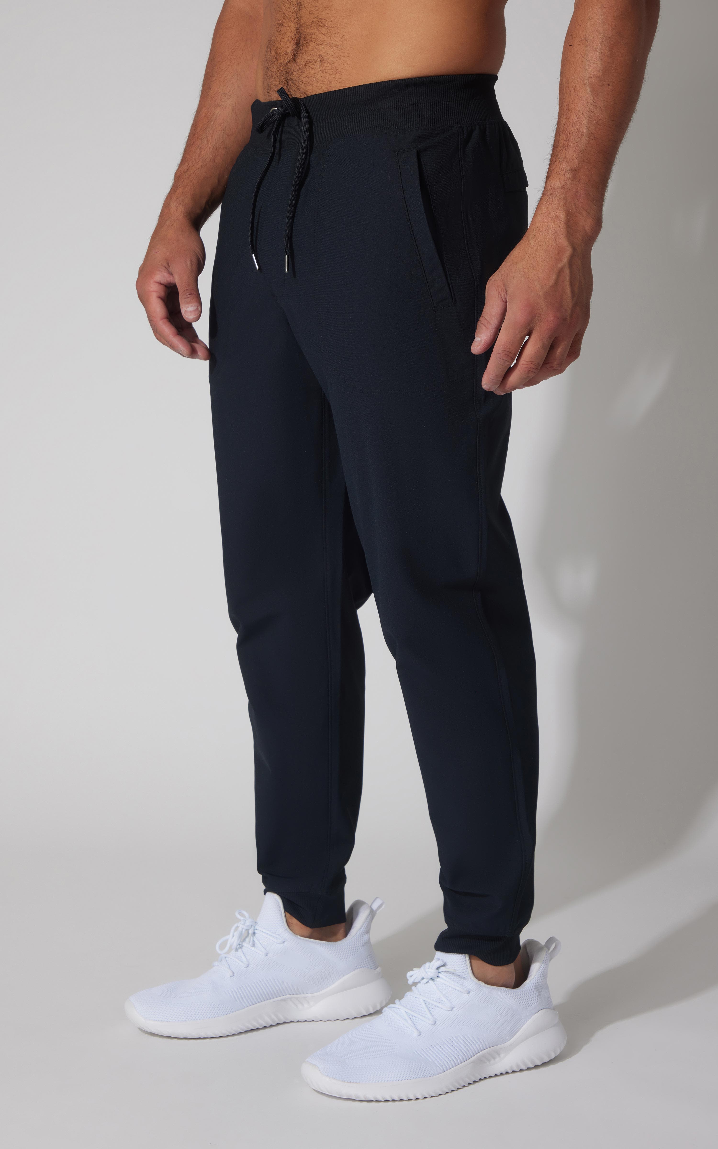 Men's true navy jogger pants with drawstring waist and tapered ankle cuffs.