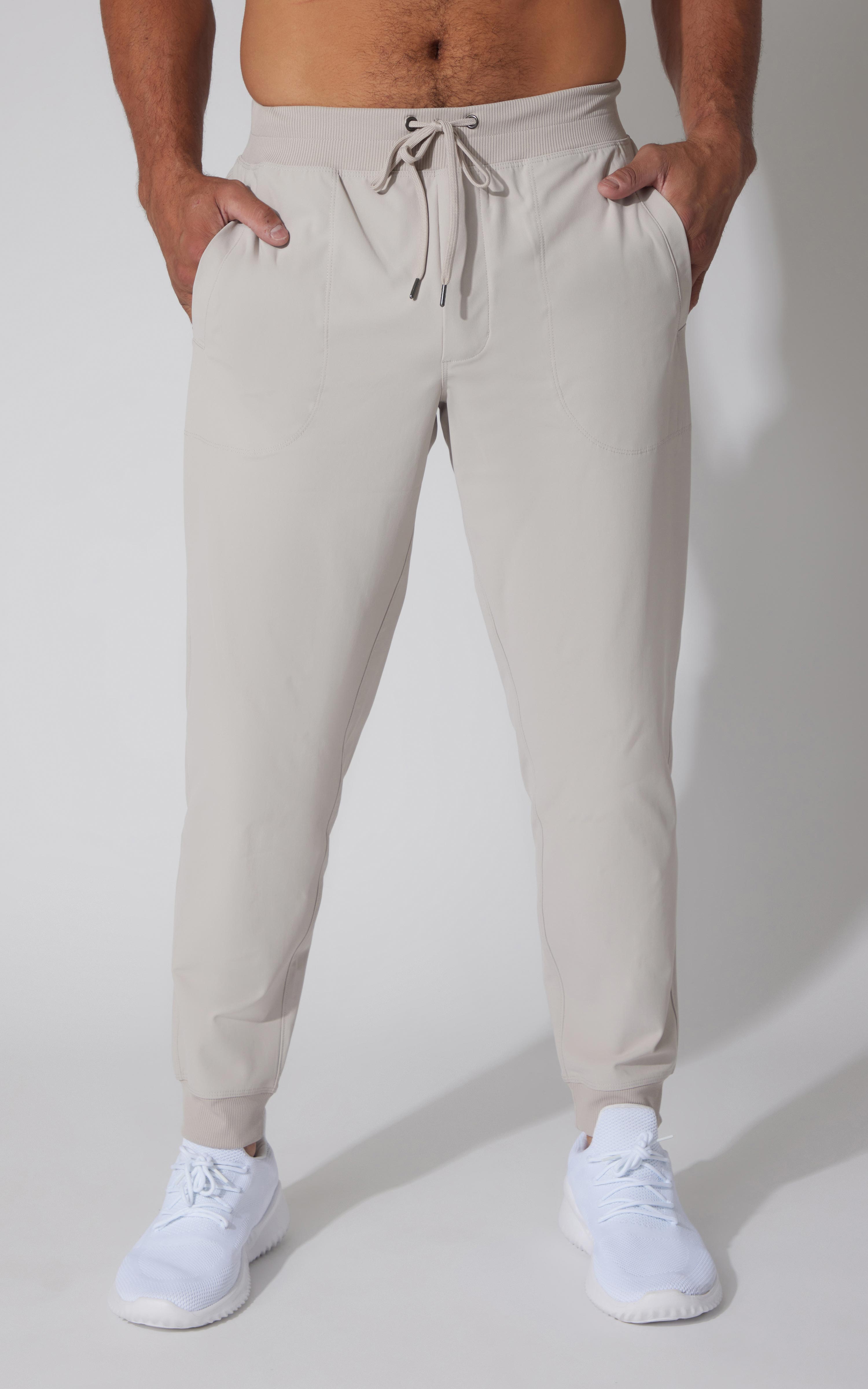 Men's light gray tricot jogger pants with elastic cuffs and adjustable drawstring waistband.