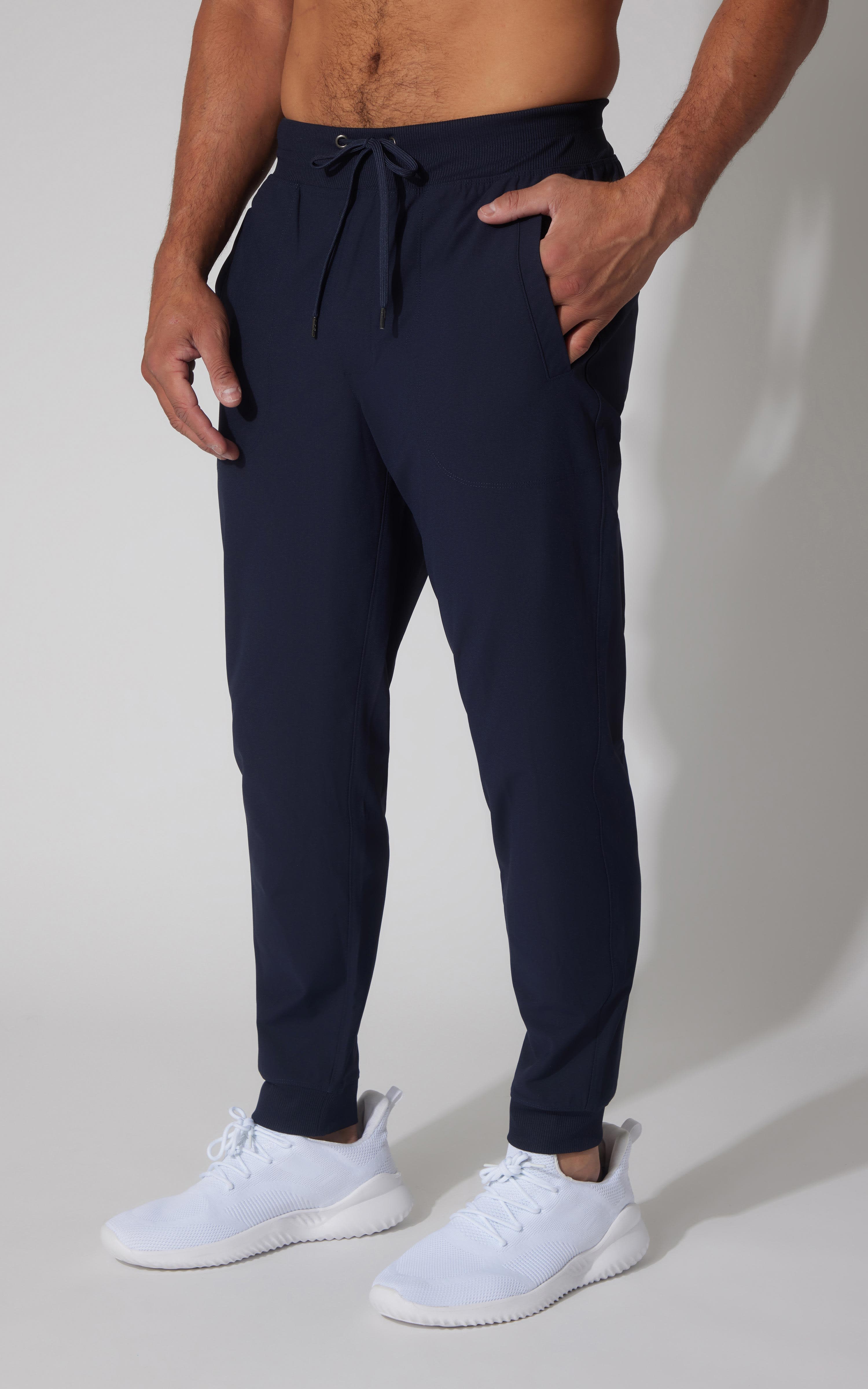 Men's true navy tricot joggers with drawstring waist and tapered ankle cuffs.