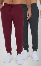 Two pairs of men's joggers, one in deep maroon and the other in dark charcoal gray, both with elastic cuffs and adjustable.