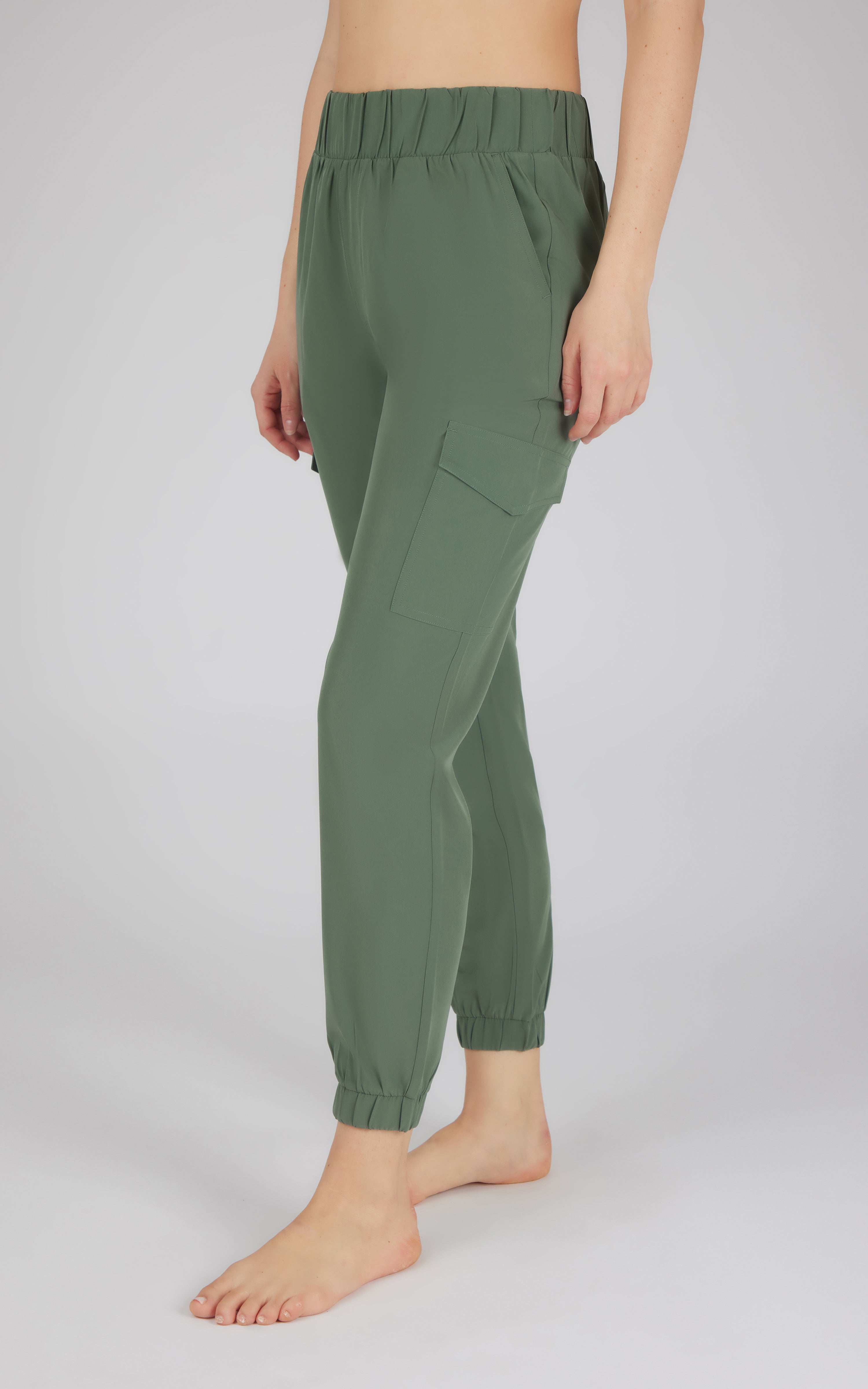 Olive green jogger pants with elastic side pocket and ankle cuffs, slim fit design.