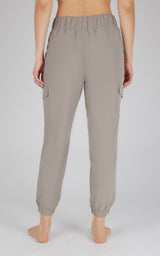 Light taupe cargo joggers with elastic cuffs and side pockets, relaxed fit, women's style.