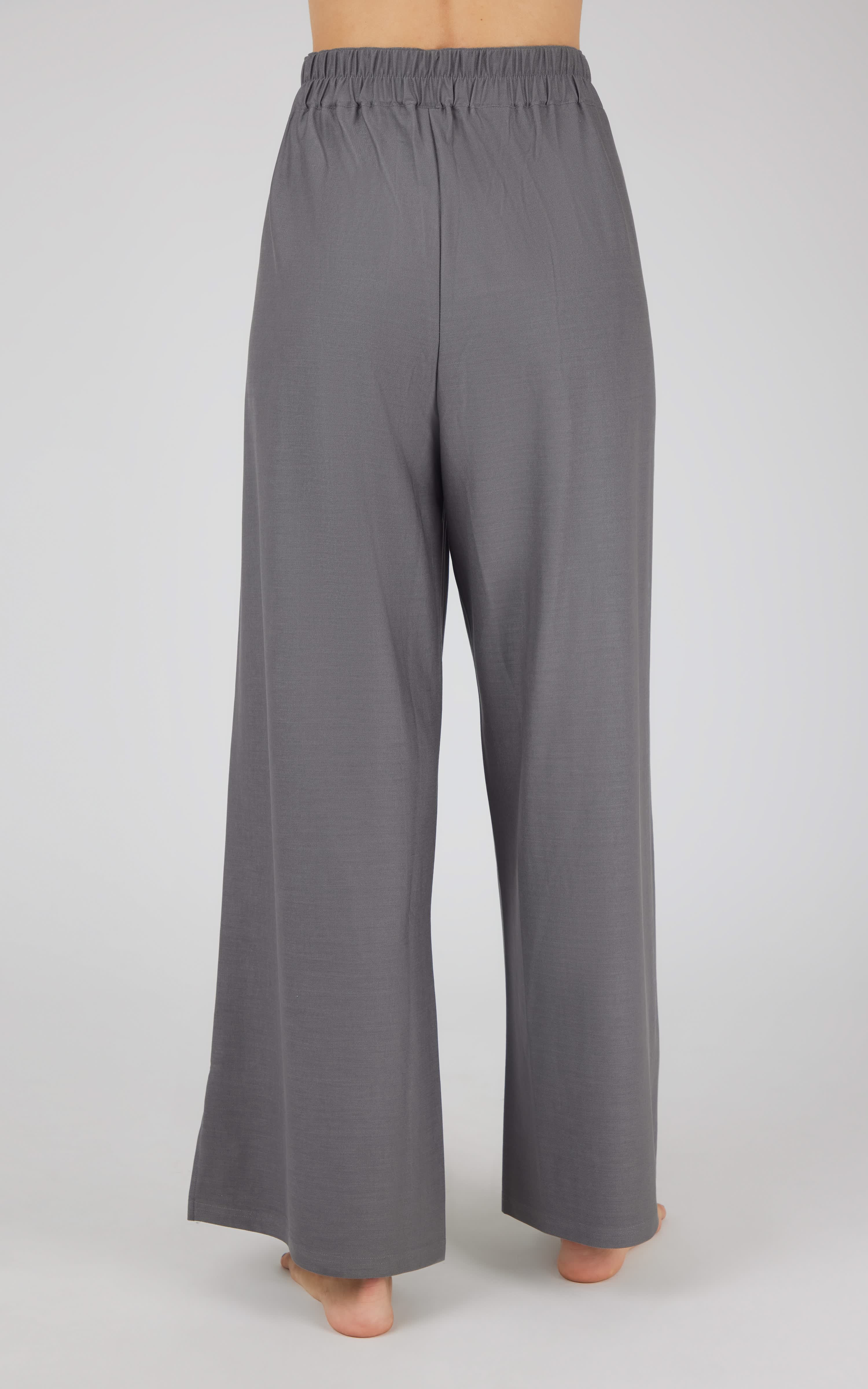 Charcoal wide-leg denim pants with elastic waistband and relaxed fit.