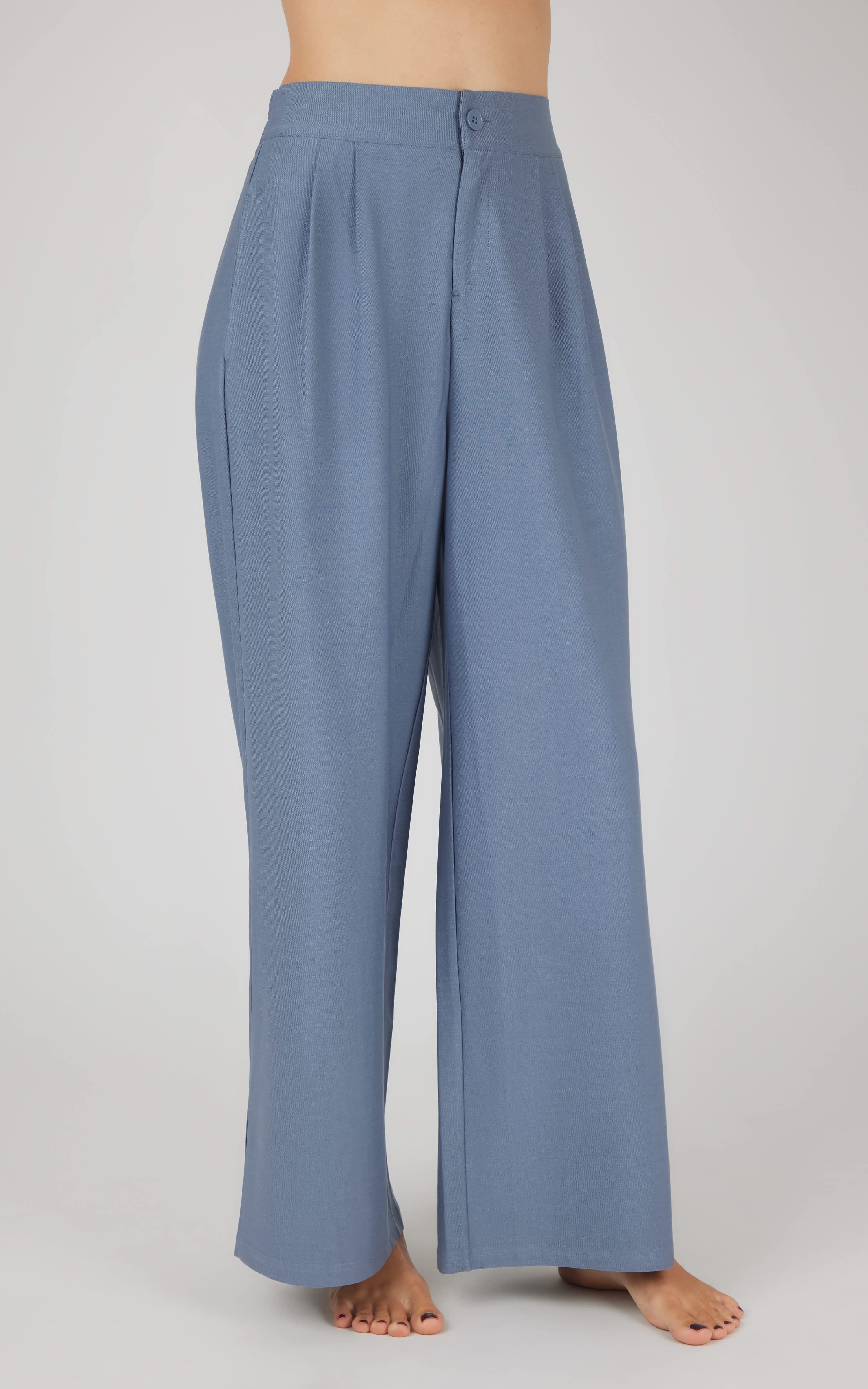 Light blue wide-leg pleated trousers for women, high-waisted with relaxed fit.