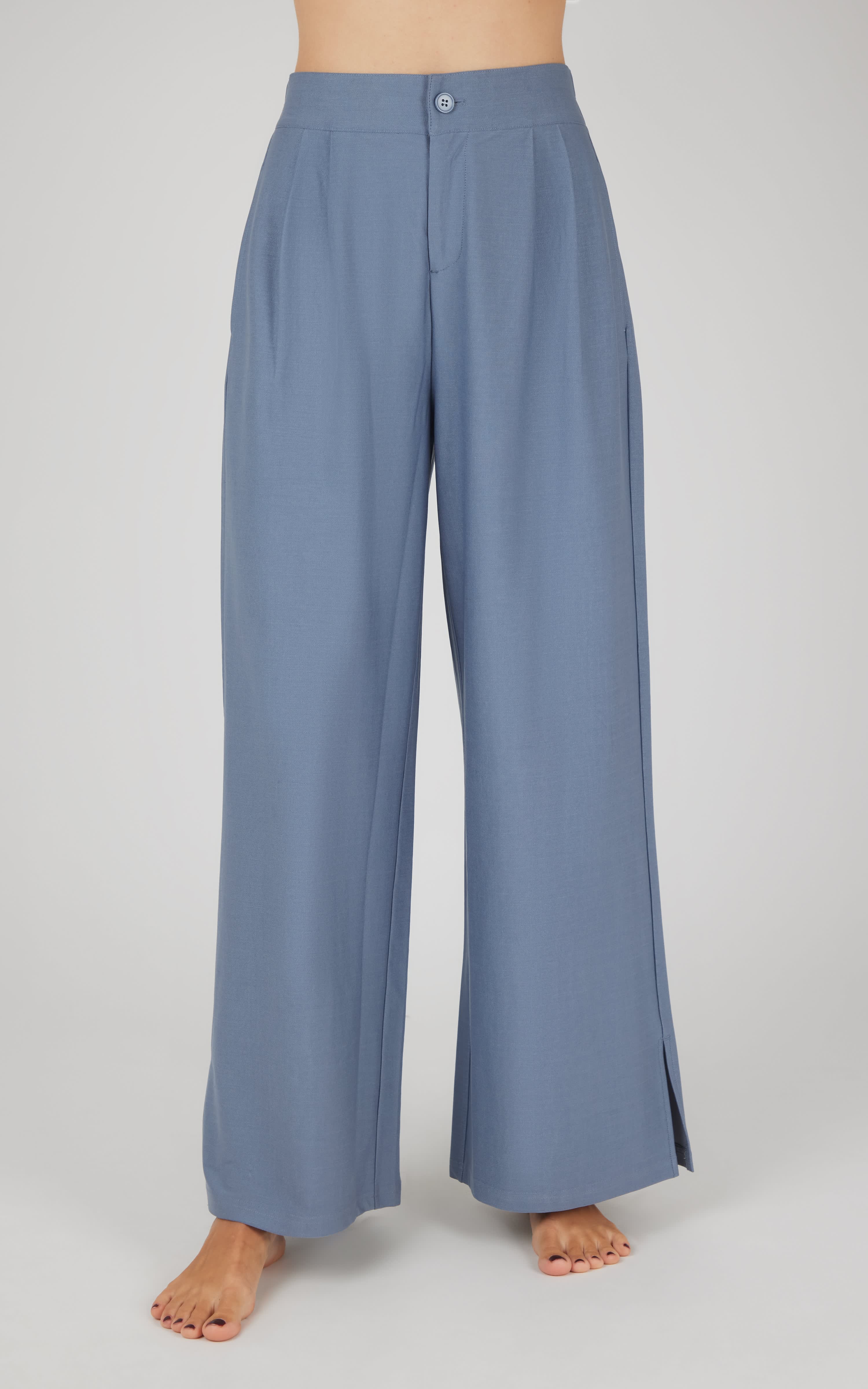 Wide-leg denim pants in muted blue with pleated front and high waist.