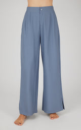 Wide-leg denim pants in muted blue with pleated front and high waist.