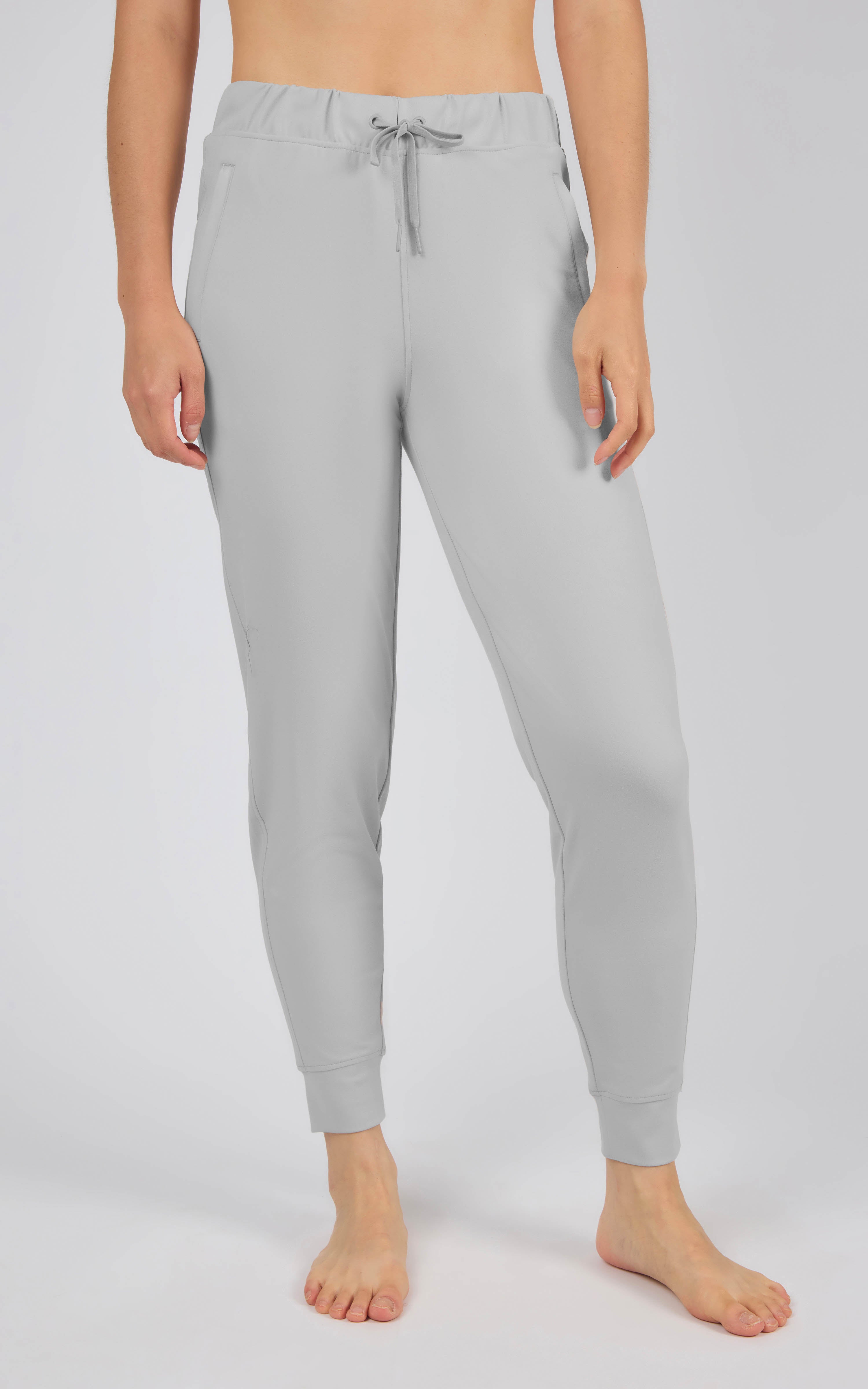 Light gray tapered joggers with an elastic drawstring waist, side pockets, and cuffed ankles.