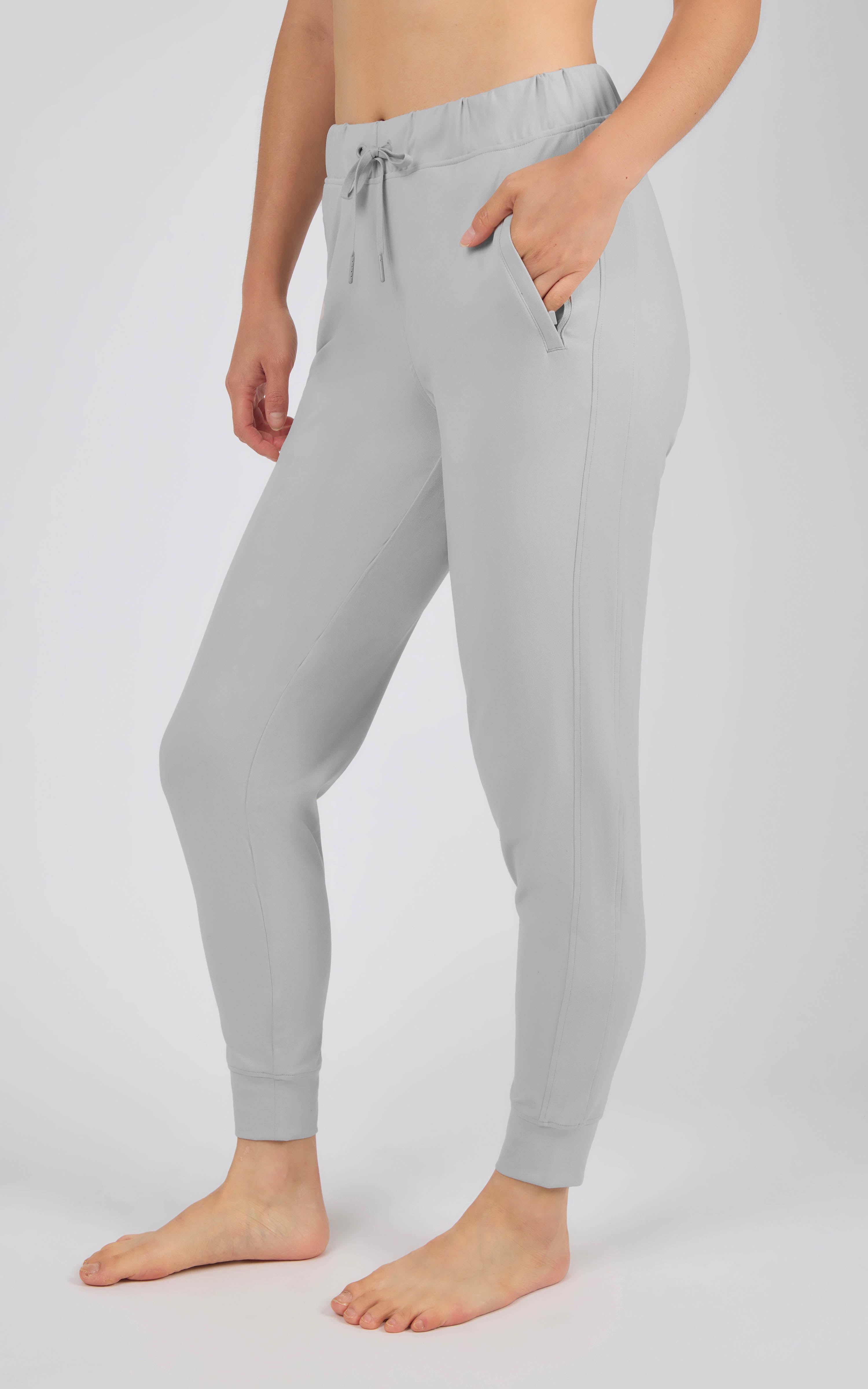 Light gray tapered joggers with an elastic drawstring waist, side pockets, and fitted ankle cuffs.