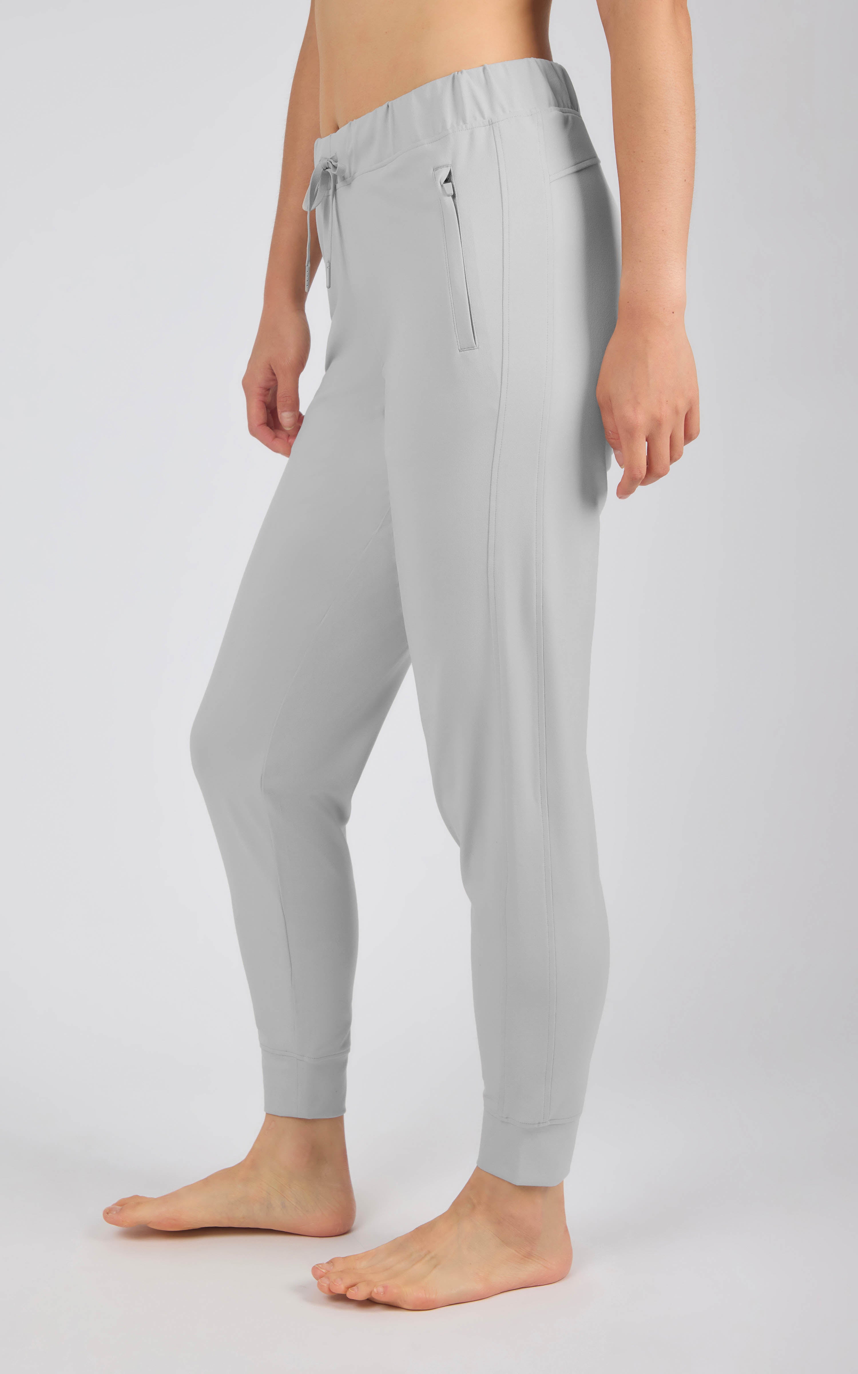 Light gray tapered joggers with an elastic drawstring waist, side pockets, and fitted ankle cuffs.