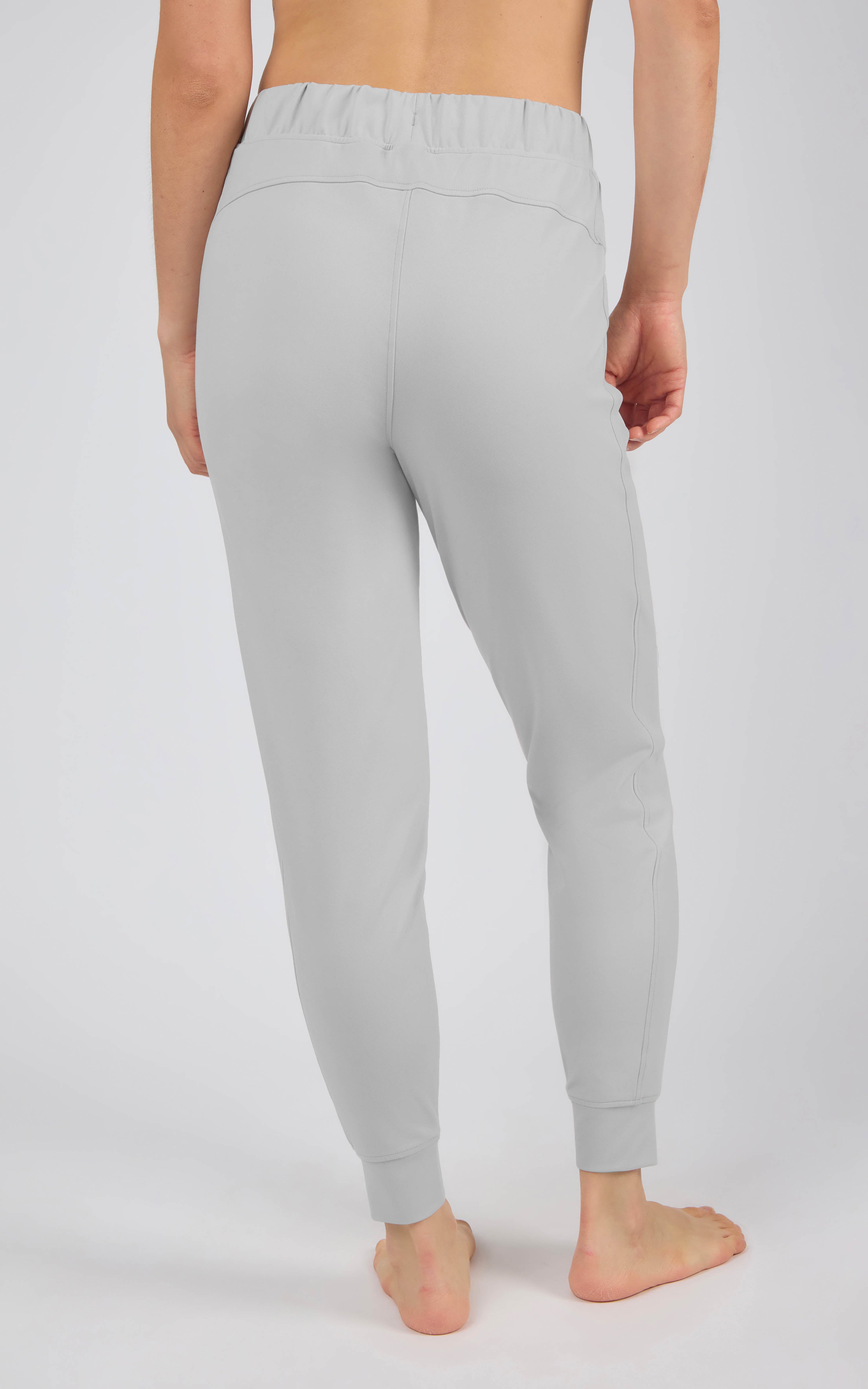 Light gray tapered joggers with an elastic drawstring waist, side pockets, and fitted ankle cuffs.