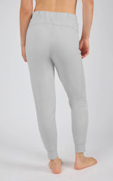 Light gray tapered joggers with an elastic drawstring waist, side pockets, and fitted ankle cuffs.