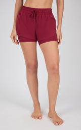 Women’s lightweight maroon running shorts with adjustable drawstring waist and relaxed fit.