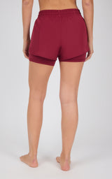 Deep burgundy lightweight running shorts with built-in inner layer and elastic waistband with drawstring, viewed from back.